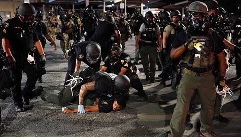 Police detain a protester during a protest in response to the police killing of George Floyd on May 30, 2020 in Atlanta, Georgia.