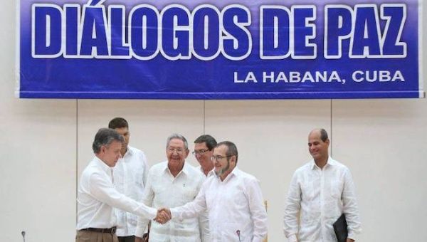 Santos and Timochenko shake hands before Raul Castro, Havana, Cuba, September, 2015.