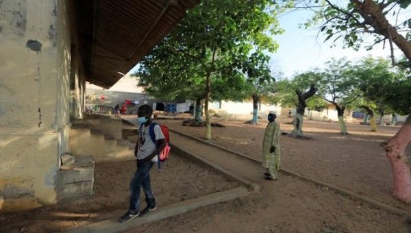 A student walks out a Pikine school, in Dakar, Senegal. June 2, 2020.