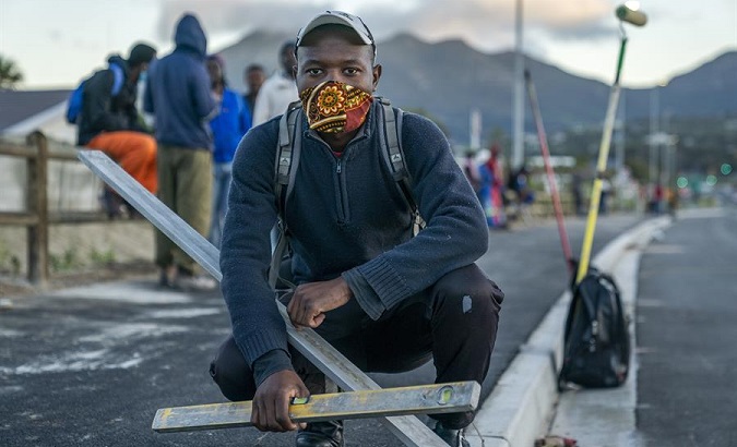 Construction worker waits for work in the informal sector, Cape Town, South Africa, June 24, 2020