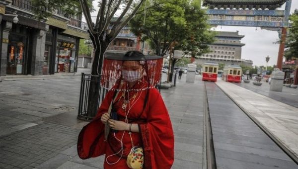A Chinese woman walks around with a mask in Wuhan, China on May 11, 2020