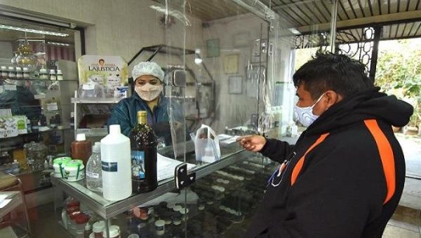 A man buys chlorine dioxide at the Bolivian pharmacy in Cochabamba, Bolivia. July 9, 2020. 