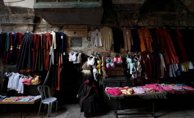 Palestinian vendor waits for customers in the alleys of Jerusalem's old city on January 29, 2020.