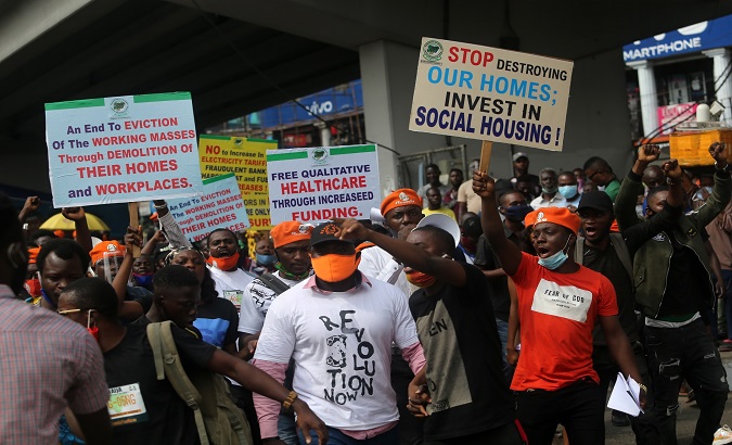 Protesters hold banners and shout slogans during a protest organized by the 'Revolution Now' group in Lagos, Nigeria. August 5, 2020.
