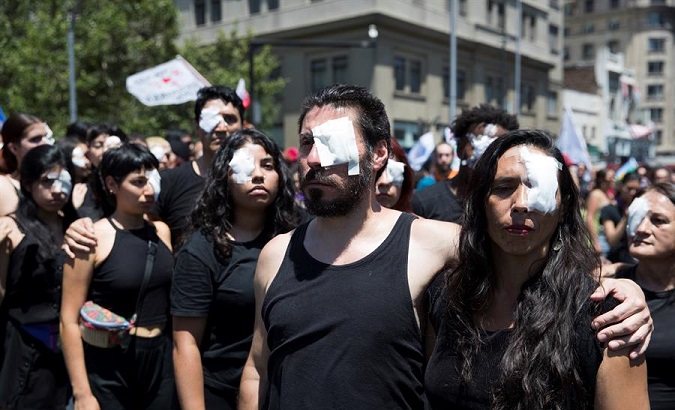 Citizens hold a protest in solidarity with the people who were shot in their eyes, Santiago, Chile, Nov. 12, 2019.