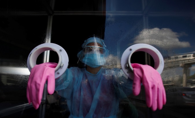Medical personnel prepare to perform coronavirus swab tests at an express station in the district of San Miguelito in Panama City, Panama. August 25, 2020.
