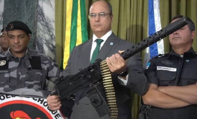 Wilson Witzel poses with a gun as he vows to fight criminals, Rio de Janeiro, Brazil, 2019.