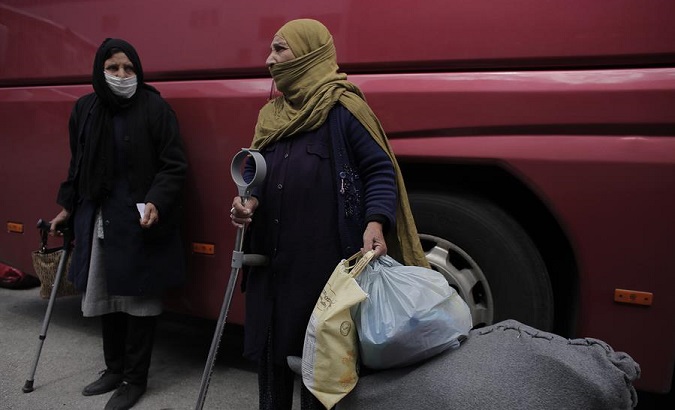 Two migrant women from Afghanistan arrive at Piraeus port, Greece, May 4, 2020.