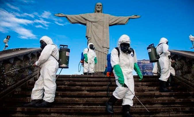 Workers disinfect a staircase at Christ the Redeemer’s Monument in Rio de Janeiro, Brazil, August 15, 2020.
