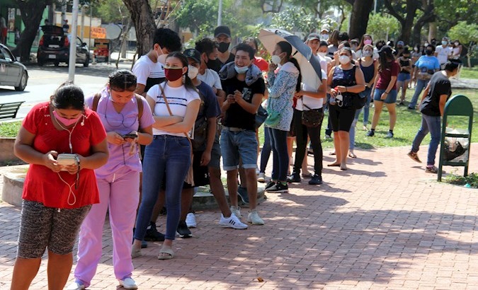 People wait to register for the October elections, Santa Cruz, Bolivia, August 28, 2020.