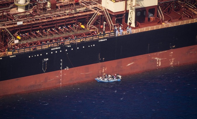 Migrants try to board an oil tanker, Mediterranean Sea, 2020.