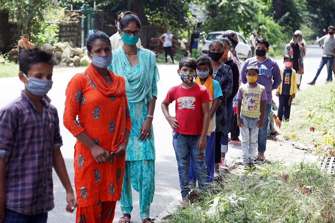 Indian people wait to give samples for Rapid Antigen Test for COVID, being conducted among slum population, contacts of a cluster of positive cases, at Bagali near Kangra, India, 07 September 2020.