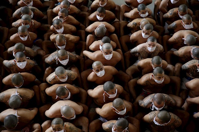 Mara Salvatrucha (MS-13) and Barrio 18 gang members remain tightly packed in formation at the Izalco Maximum Security Prison in Izalco, El Salvador. September 04, 2020.