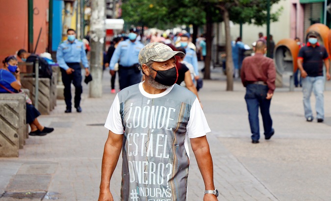 A man wears a T-shirt that reads 