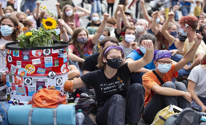 Climate activists occupy the Bundesplatz square in front of the Swiss parliament building, the Bundeshaus, where the Swiss parliament currently holds its fall meeting, during a 'Rise up for Change' week of action, in Bern, Switzerland, September 22, 2020.