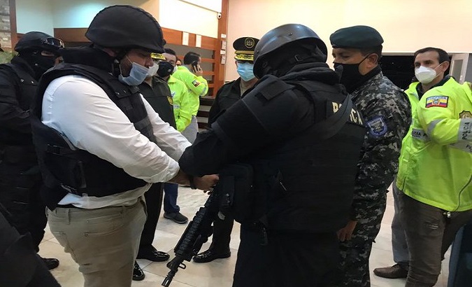 National Police officers put handcuffs on Jacobo Bucaram after his arrival in Ecuador, Sept. 26, 2020.
