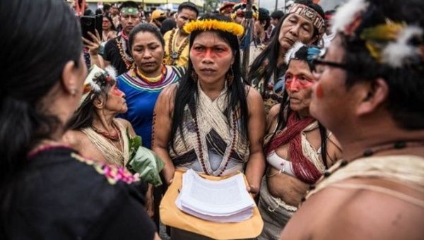 Nemonte Nenquimo holds the Waorani people's written demands to stop oil extraction in their territory, Feb., 2020, Puyo, Ecuador.