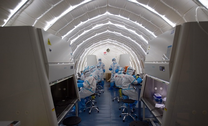 Staff members work in an inflatable COVID-19 testing lab in Beijing, China, June 23, 2020.