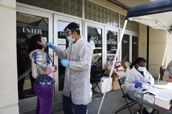 A woman gets COVID-19 test at a makeshift test site in Kew Gardens, one of the COVID-19 hotspot areas in New York City, the United States, Oct. 6, 2020.