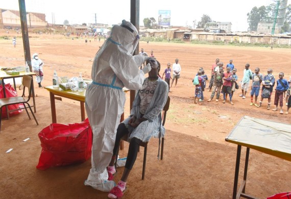A health worker takes swab sample from a girl during COVID-19 mass testing exercise in Kangemi, Nairobi, capital of Kenya, on Oct. 17, 2020.