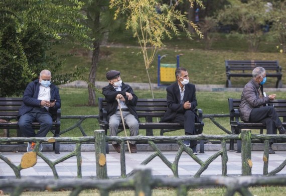 People wearing face masks sit at Mellat park in Tehran, Iran on Oct. 25, 2020.