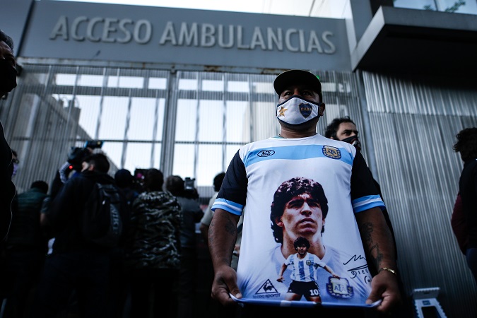 A man shows a T-shirt with a picture of former Argentinean soccer player and coach Diego Armando Maradona, who was successfully operated on today at a clinic in Olivos, in the province of Buenos Aires (Argentina).