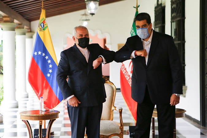 A handout photo made available by Miraflores Press shows Venezuelan President Nicolas Maduro (R) and Iranian Foreign Minister Javad Zarif (L) posing for a photo after their meeting in Caracas, Venezuela, 05 November 2020.