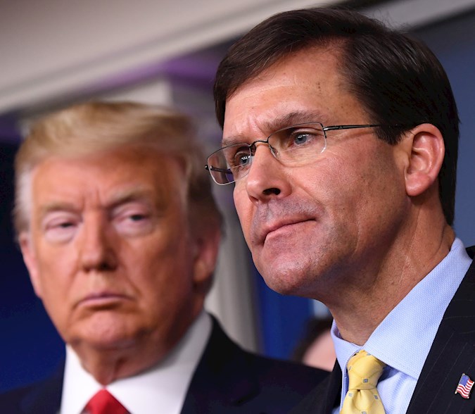 Secretary of Defense Mark Esper (R) delivers remarks on the COVID-19 pandemic as U.S. President Donald J. Trump looks on in the White House. Washington, DC, USA. March 18, 2020.