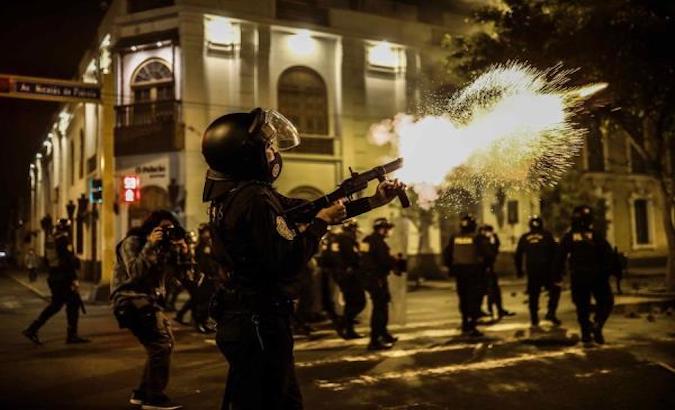 Police disperse demonstrators marching towards the Government Palace and the Legislative Palace in Lima, Peru, Nov. 10, 2020.