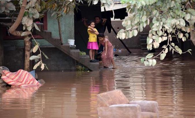 A family returns home during heavy flooding, Sula Valley, Honduras, Nov. 19, 2020