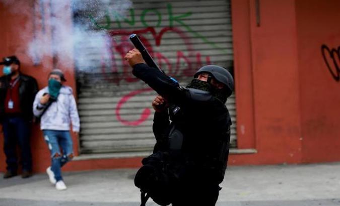 Police throw tear gas at protesters, Guatemala City, Nov. 21, 2020.