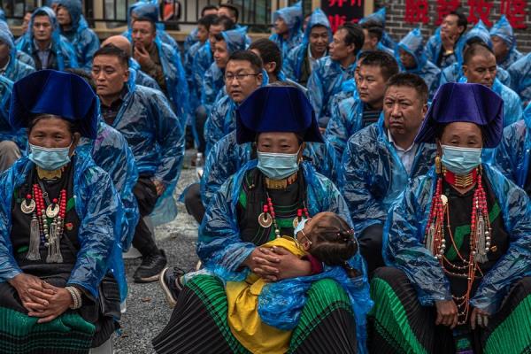 Rural farmers attend night school gathering during a media tour in Xiaoshan village, Xide county, Sichuan province. In 2012 President Xi Jinping launched a plan to eliminate poverty in rural areas. September 11, 2020.