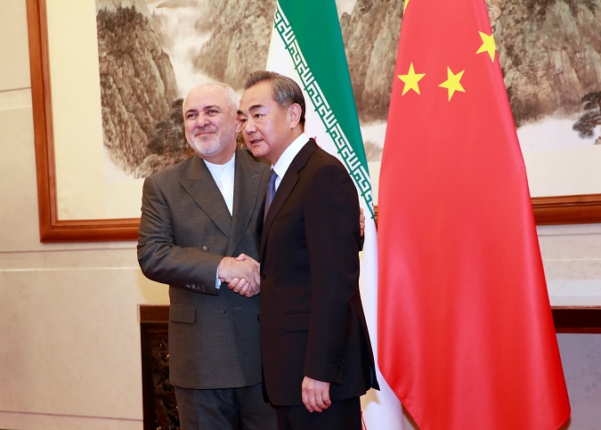 Archival photo of Chinese Foreign Minister Wang Yi (R) shaking hands with Iranian Foreign Minister Mohammad Javad Zarif at the Diaoyutai State Guesthouse in Beijing, China, during a regional tour by the Iranian FM, in 2019.