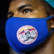 Citizen wears a mask with the image of Commander Hugo Chavez, Caracas, Venezuela, Nov. 29, 2020.