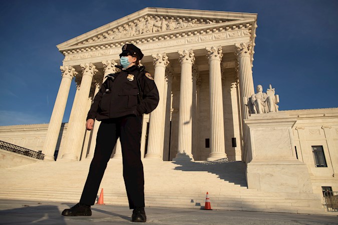 A US Supreme Court police officer stands outside the Supreme Court in Washington, DC, USA, 11 December 2020