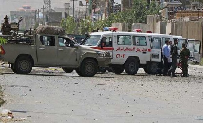 Security forces and Red Cross member at the explosion site in Gilan, Afghanistan, Dec. 18, 2020.
