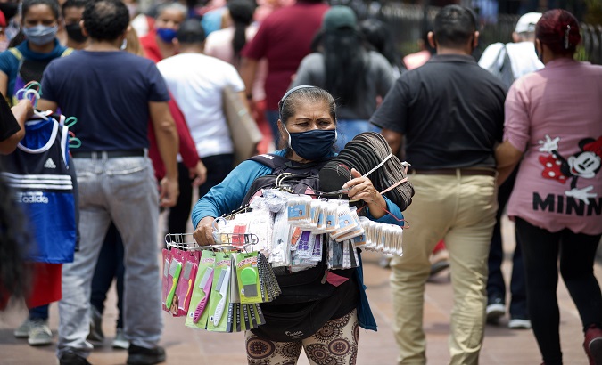 An informal saleswoman offers her products on the streets, Guayaquil, Ecuador, Dec. 18, 2020.