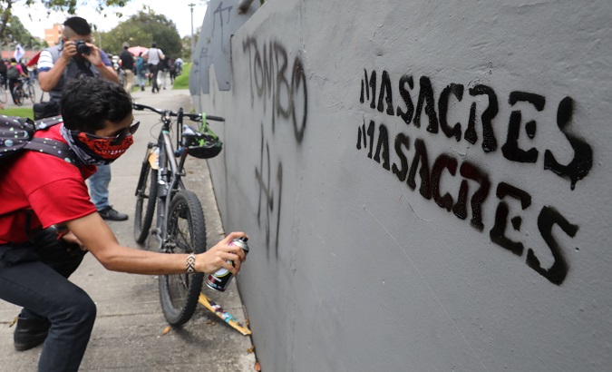 A student graffitiing during a protest against the massacres, Bogota, Colombia, Dec. 18, 2020.