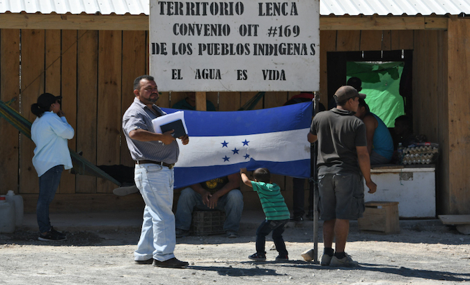 Lenca Indigenous people stand by a sign reading 'Water is life' in La Paz, Honduras, 2018.