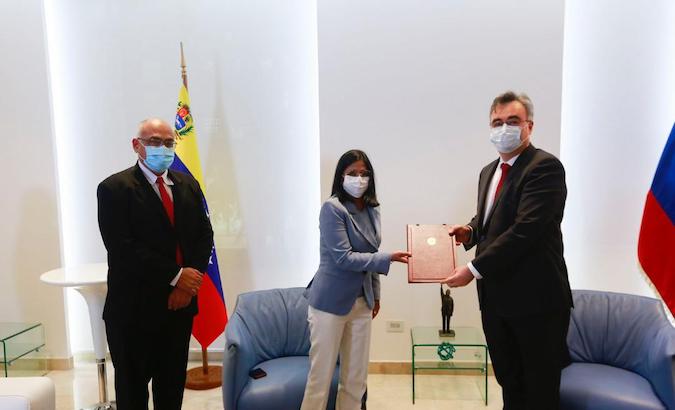 Venezuela's Health Minister Carlos Alvarado (L), Vice President Delcy Rodriguez (C), and Russian Ambassador Serguei Melik-Bagdasarov (R), Caracas, Venezuela, Dec. 29, 2020.