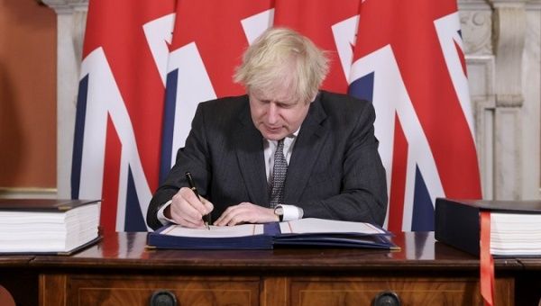 PM Boris Johnson signs the post-Brexit trade deal, London, Britain, Dec. 30, 2020.