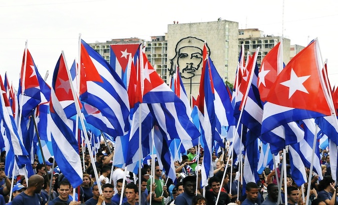 A group of young people parade with flags through the Revolution Square, Havana, Cuba, May 1, 2019.