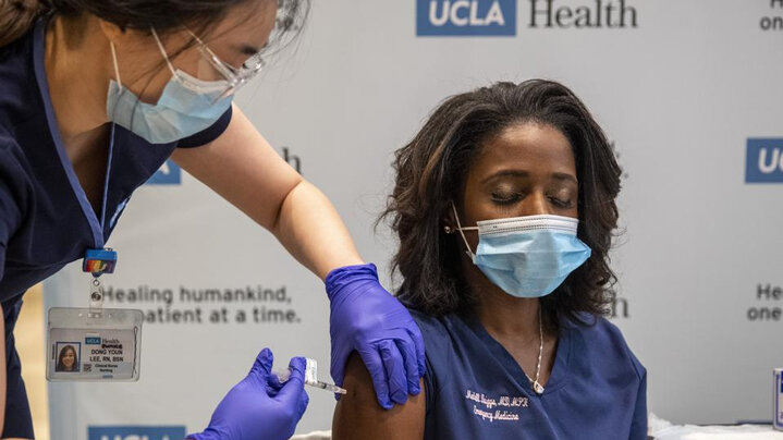 A health worker from the UCLA health system getting vaccinated with the Pfizer/BioNTech vaccine in Los Angeles, California, USA.