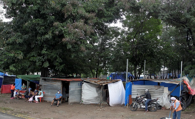 People rest in makeshift houses after passing of hurricane Iota, Tegucigalpa, Honduras, Nov. 19, 2020.