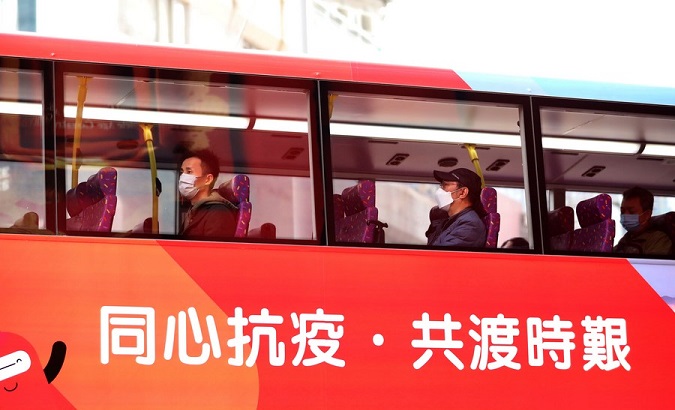 People wearing face masks are seen on a bus in Hong Kong, China, Jan. 5, 2021.