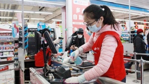 A staff member disinfects the equipment at a supermarket, Beijing, China, Jan. 6, 2021.