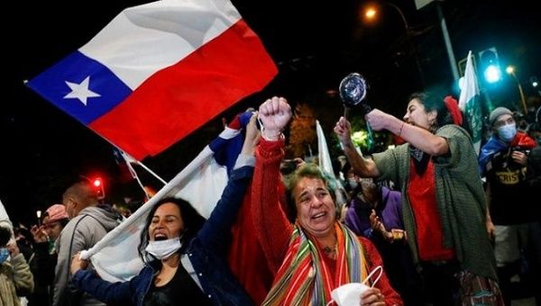 People celebrate the approval of a new Constitution's drafting process, Santiago de Chile, Oct. 25, 2020. 