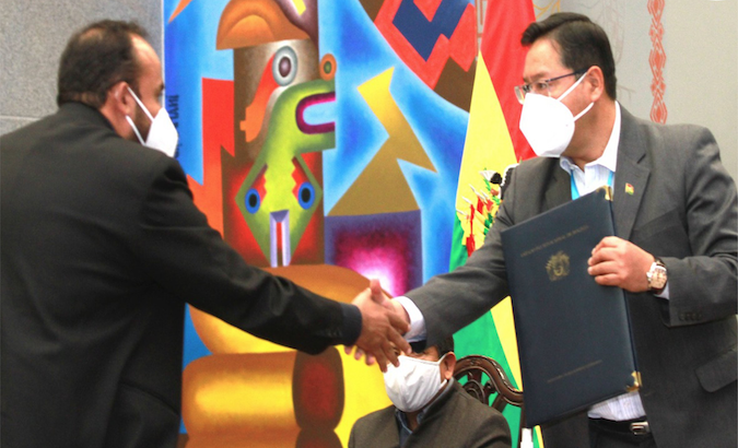 President Luis Arce (R) greets a representative of the Indian Serum Institute, La Paz, Bolivia, Jan. 13, 2021.
