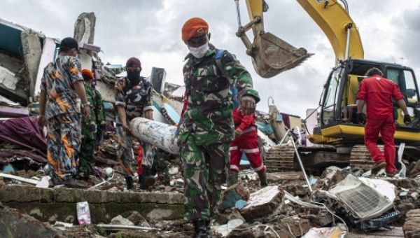 Rescuers work on damaged buildings after a 6.2-magnitude earthquake hit Mitra Manakarra hospital in Mamuju, West Sulawesi, Indonesia, Jan. 17, 2021.