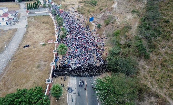 Soldiers and police form a human barricade to stop Honduran migrants walking on a highway, Guatemala, Jan. 18, 2021.